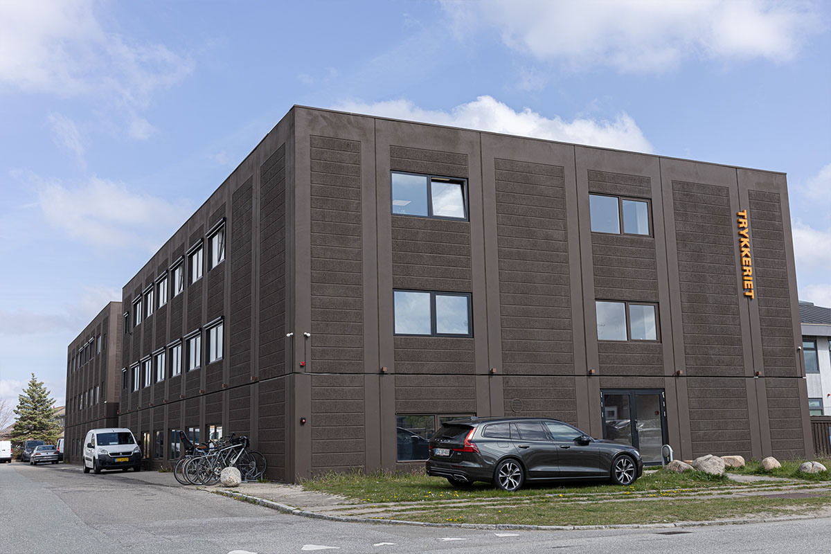 Modern brick apartment building against a blue sky